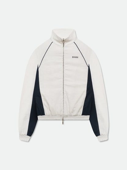 White track jacket with navy side panels, navy piping, a stand collar, full zip and small black RHUDE chest logo, front view