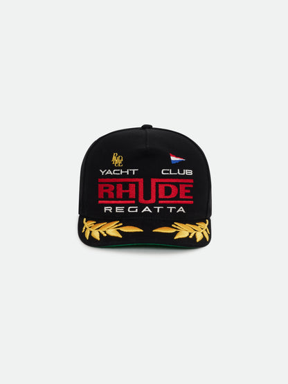 Black cap with red RHUDE lettering, white “Yacht Club” and “Regatta” text and gold laurel embroidery on the brim, front view