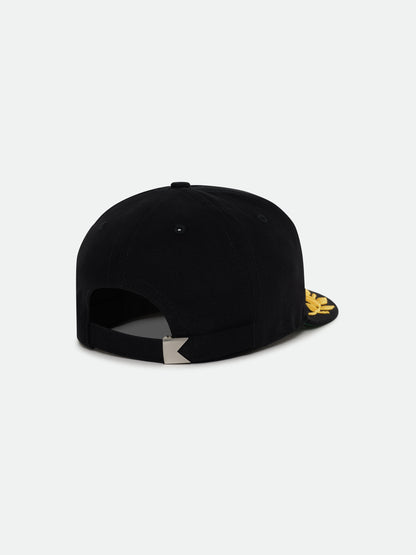 Black Regatta cap, back view showing the adjustable strap with a metal clasp and gold laurel brim