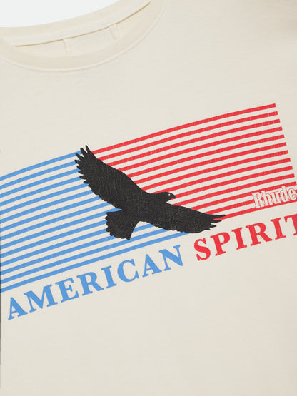 Close-up of the black eagle, blue and red stripes, small Rhude logo and “American Spirit” print on the vintage white tee
