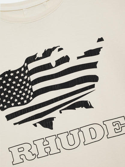 Close-up of the black American flag print and outline RHUDE lettering on the vintage white tee