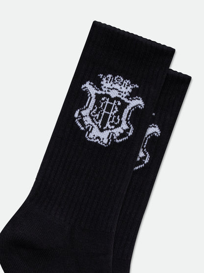 Close-up of the white crowned monogram crest knitted into the black ribbed socks