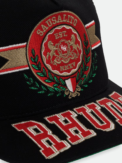 Angled close-up of the embroidered Sausalito “Est. MMXV” crest, green laurels and red RHUDE brim lettering on the black hat