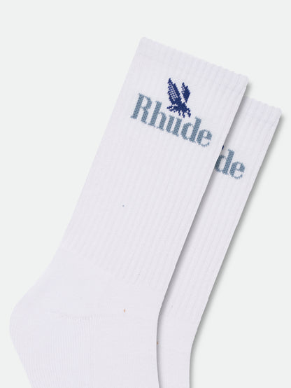Close-up of the knitted blue eagle and Rhude logo on the white ribbed socks