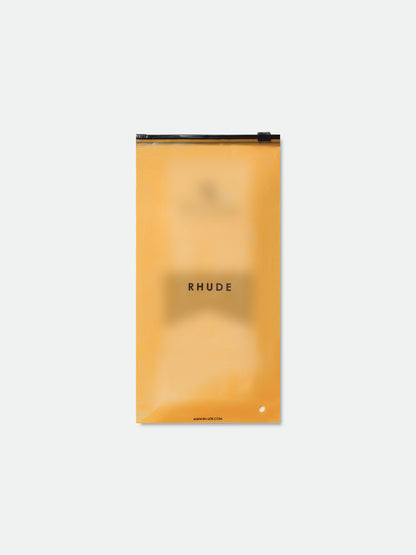 Rhude socks folded inside translucent orange zip packaging with a RHUDE label