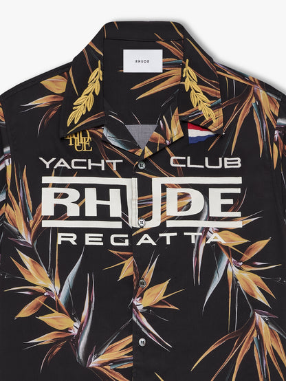 Close-up of the gold laurel collar, pennant flag and cream “Yacht Club” RHUDE Regatta print on the bird of paradise shirt