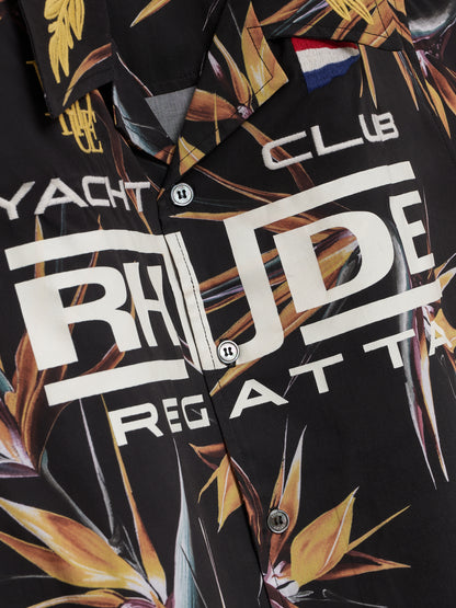 Angled detail of the cream RHUDE Regatta print and buttons on the black bird of paradise shirt