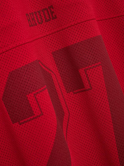 Angled close-up of the tonal RHUDE logo and number 27 on the red mesh fabric