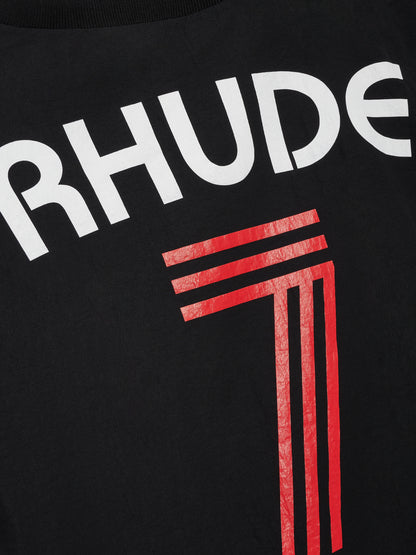 Close-up of the white RHUDE lettering and cracked red 7 print on the back of the black crewneck