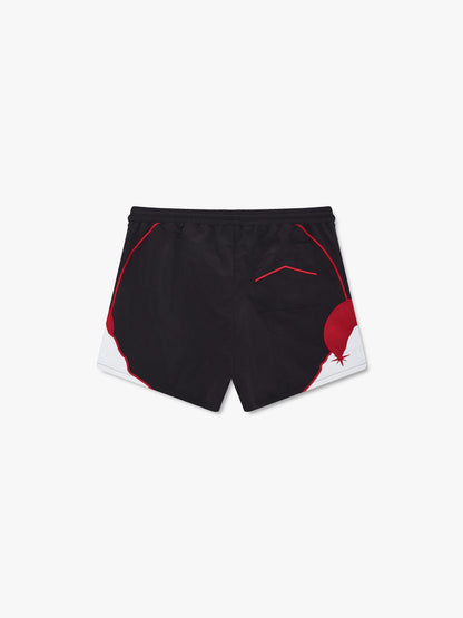 Black shorts with red piping, red and white moon and mountain hem panels and a red chevron back pocket, back view