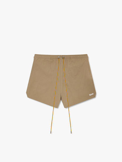 Khaki twill shorts with long tan drawcords, metal eyelets and a small white Rhude logo at the hem, front view