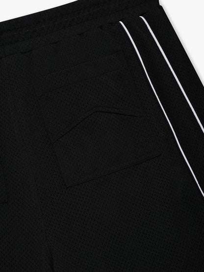 Detail of the black mesh fabric and chevron-stitched back pocket beside the white piping