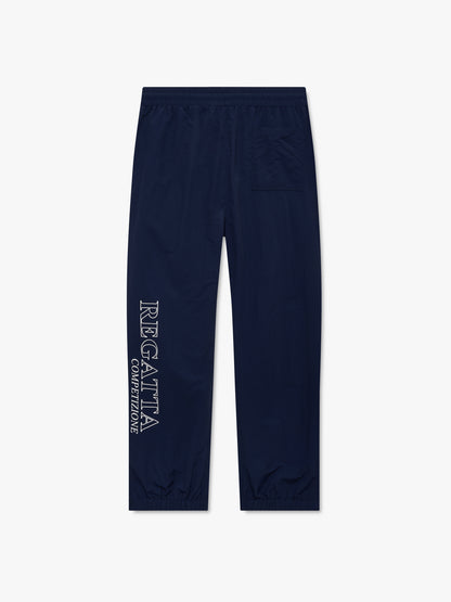 Navy track pants with a white outlined “Regatta Competizione” print down the leg and a rear patch pocket, back view