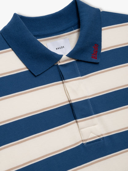 Close-up of the blue collar with red Rhude embroidery and RHUDE neck label on the off-white and blue striped polo