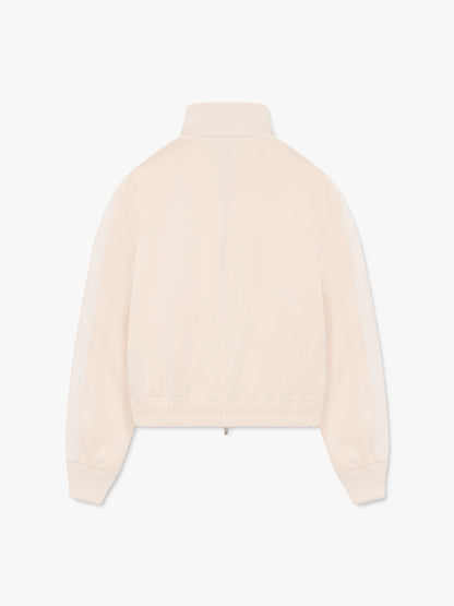 Cream track jacket with tonal shoulder stripes and an elastic hem, back view