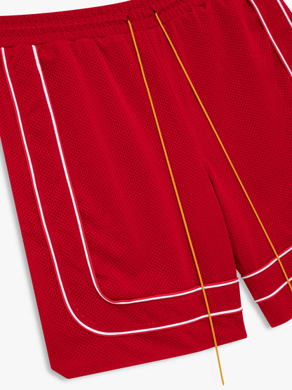 Angled close-up of the white piping and tan drawcords on the red mesh shorts