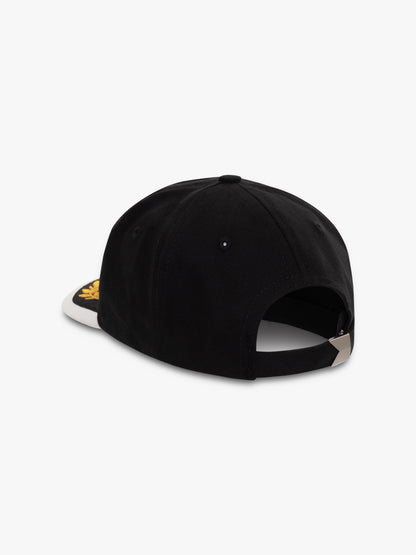 Black cap with a white brim, back view showing the adjustable strap and metal buckle