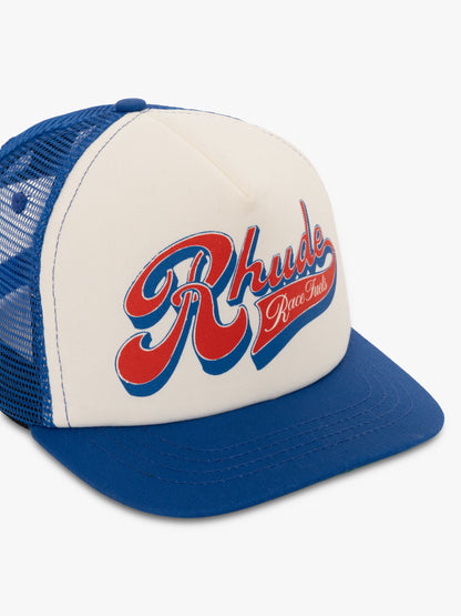 Cream and blue Race Fuels trucker hat, three-quarter view showing the blue mesh side panels
