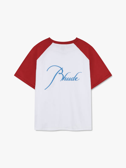 White raglan tee with red sleeves and large sky blue script Rhude embroidery across the back, back view