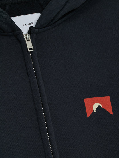 Close-up of the zip, white RHUDE neck label and small red mountain logo on the vintage black zip-up hoodie