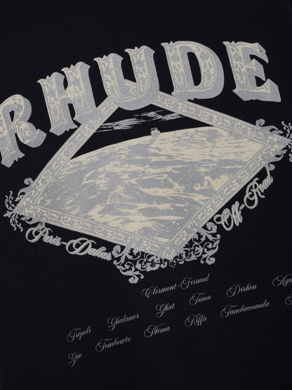 Close-up of the silver RHUDE diamond-framed desert print and script place names on the vintage black tee
