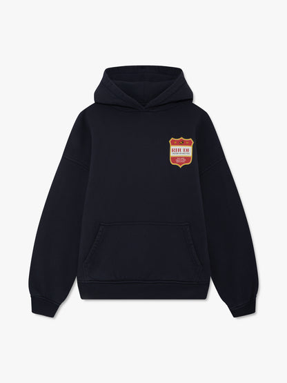 Vintage black hoodie with a small red and gold RHUDE Filter Cigarettes crest on the chest and pouch pocket, front view
