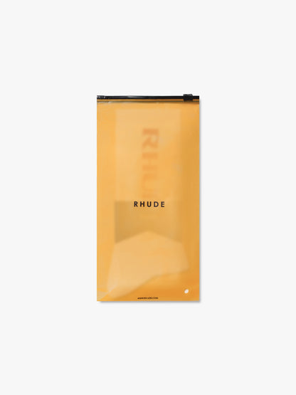 Rhude logo socks in their translucent orange zip packaging