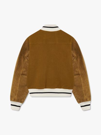 Mustard varsity jacket, back view with leather sleeves, a yoke seam and cream and black striped rib trims
