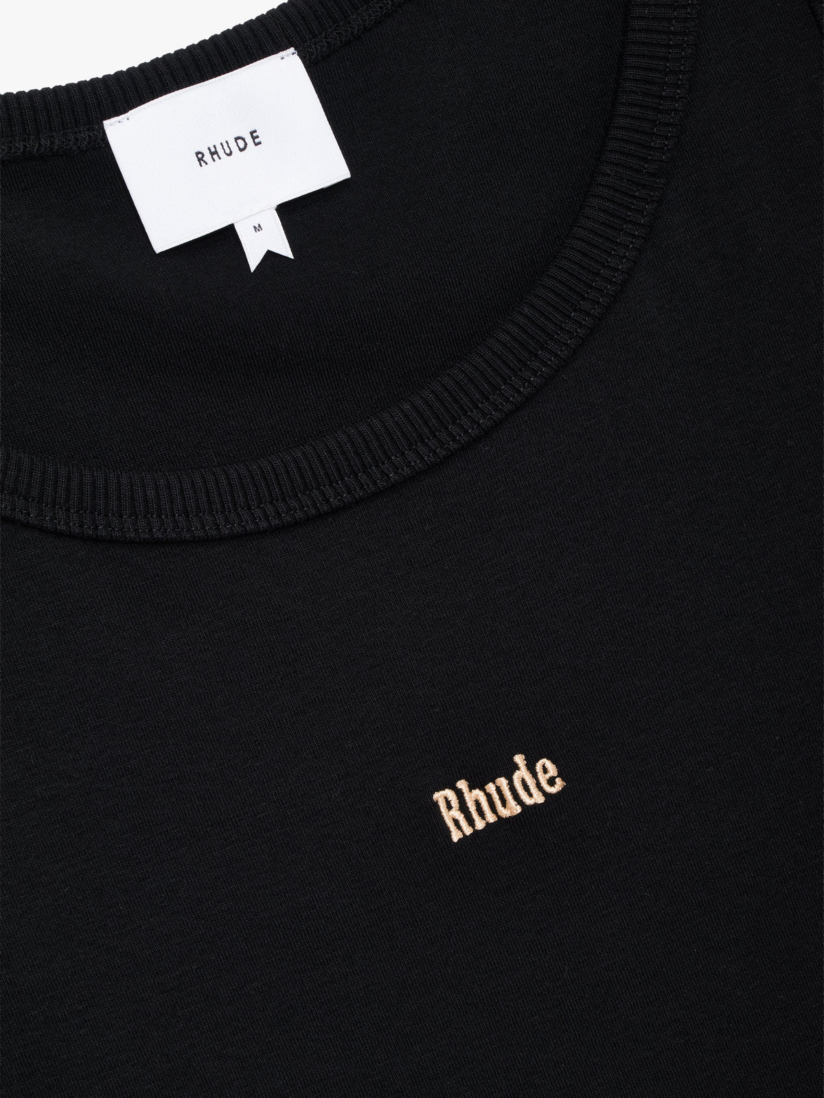 Close-up of the ribbed neckline, RHUDE neck label and peach embroidered Rhude logo on the black tank top