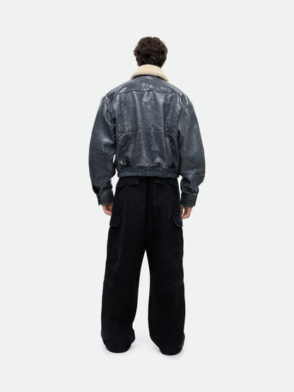 Model wearing the navy pilot jacket with black wide-leg cargo trousers, full-length back view