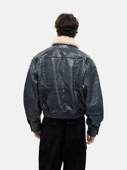 Model wearing the navy crocodile-textured pilot jacket with a plush cream collar, back view