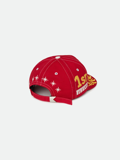 Red cap, back view with white embroidered stars, a gold “1st” on the side and an adjustable strap with metal clasp