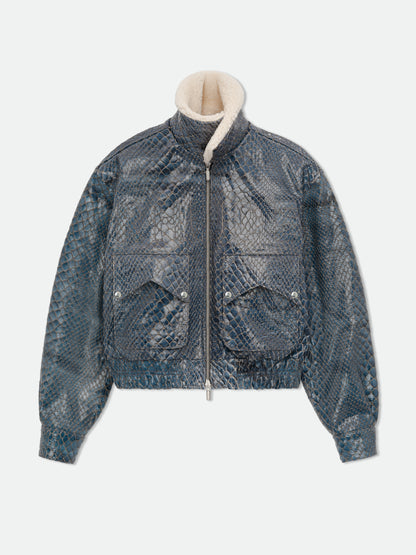 Navy crocodile-textured pilot jacket zipped to the top with the plush cream collar standing up, front view