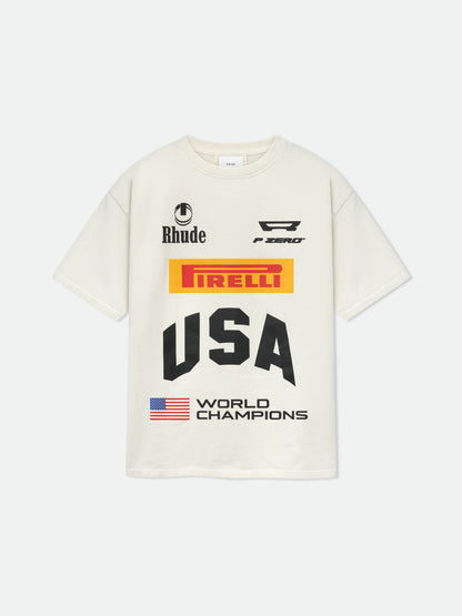 Vintage white tee with Rhude, “P Zero” and yellow Pirelli logos, black “USA” and a US flag “World Champions” print