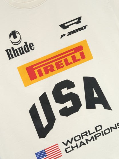 Close-up of the Rhude, “P Zero” and yellow Pirelli logos above the black “USA” and “World Champions” print on the tee