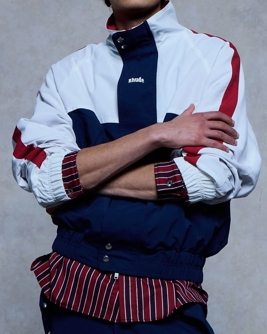 RHUDE Regatta colour-blocked track jacket worn over a striped shirt